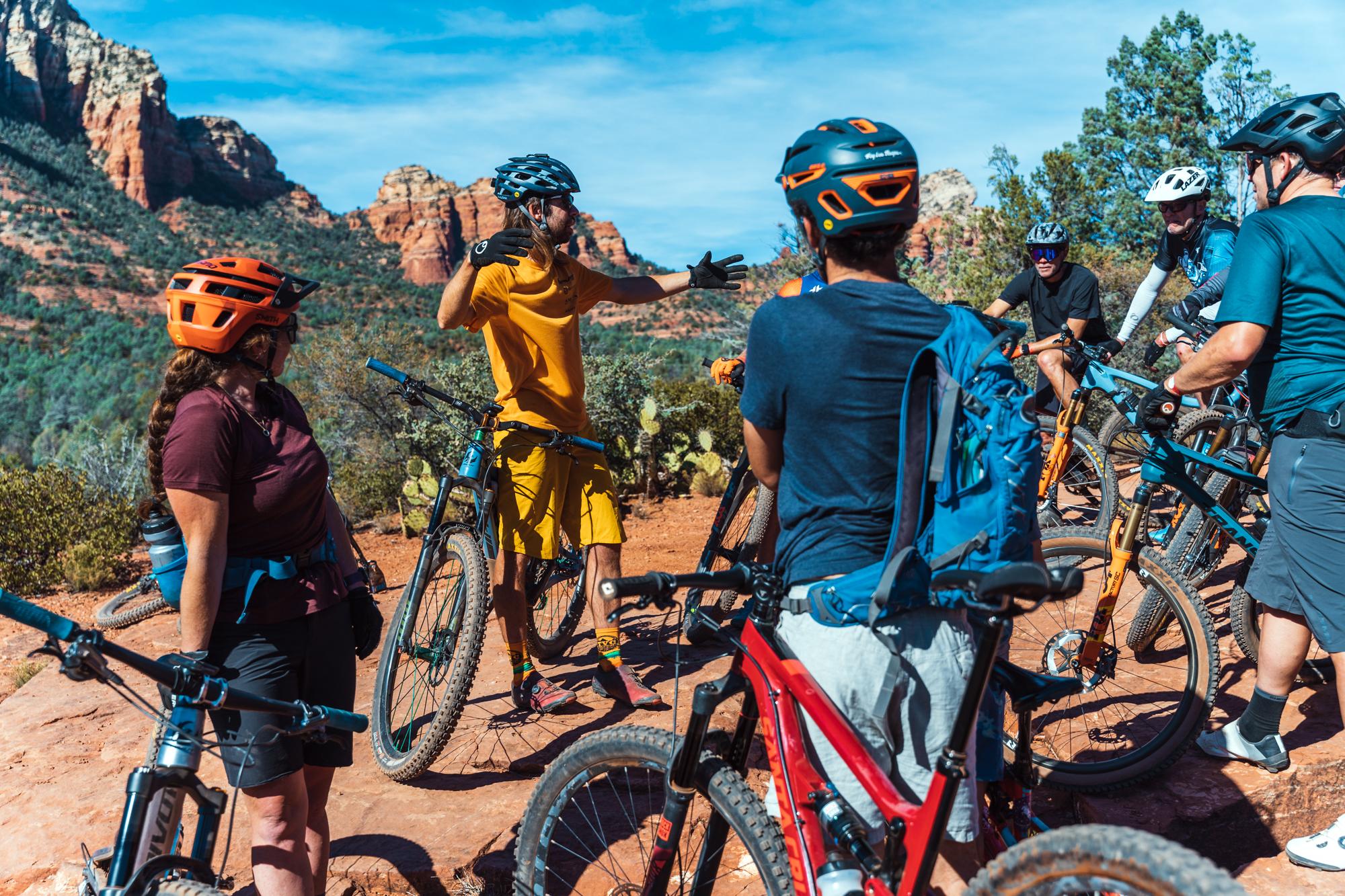 Group of people on a Sedona bike tour/></p>

<h4>E-Bike Tours</h4>

<p>E-bike rentals are also offered in Sedona. These experiences blend the thrill of biking with the ease of electric assistance. Specific rental shops provide a variety of e-bike options and guided e-bike tours, led by knowledgeable locals. Note that the trails accessible to e-bikes are generally not the same as the trails offered to mountain bikers, and tend to include more beginner-friendly paths centered around scenic views.</p>

<h4>Ride In, Ride Out from Enchantment Resort Sedona</h4>

<p>Enchantment Resort in Sedona, AZ, offers a serene escape amidst the stunning red rock landscape. Nestled in Boynton Canyon, the resort combines luxury with natural beauty, providing a secluded and rejuvenating experience. The 
